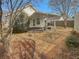 Backyard patio with a covered seating area and a well-maintained landscape at 207 Autumn Lake Way, Mcdonough, GA 30253