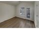A bedroom featuring a door to the deck, neutral walls, and lovely wood-look floors at 207 Autumn Lake Way, Mcdonough, GA 30253