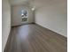 A bright bedroom featuring a ceiling fan, neutral walls, and lovely wood-look floors at 207 Autumn Lake Way, Mcdonough, GA 30253