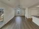 Bright living room featuring a ceiling fan, neutral walls, and lovely wood-look floors at 207 Autumn Lake Way, Mcdonough, GA 30253