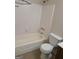Bathroom featuring a tub with shower, tile surround, and toilet at 2627 Evans Mill Dr, Lithonia, GA 30058