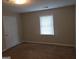 Neutral bedroom featuring a window and a closed door at 2627 Evans Mill Dr, Lithonia, GA 30058