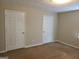 Neutral bedroom featuring two closed doors at 2627 Evans Mill Dr, Lithonia, GA 30058