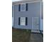 Charming townhome with gray siding, black shutters, and a secure metal door at 2627 Evans Mill Dr, Lithonia, GA 30058