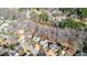 Aerial view of the property showcases a house nestled in a wooded area near a pond at 4314 Deep Springs Nw Ct, Kennesaw, GA 30144