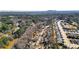 Expansive aerial view of a community with lush trees and nearby river, homes, and distant mountain view at 4314 Deep Springs Nw Ct, Kennesaw, GA 30144