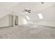 Finished attic space with neutral carpet, skylights and ceiling fan at 4314 Deep Springs Nw Ct, Kennesaw, GA 30144