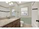 Bathroom with a large vanity, tiled bathtub and a window, providing natural light at 4314 Deep Springs Nw Ct, Kennesaw, GA 30144