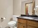 Bathroom features a black granite counter atop a wooden cabinet and an adjacent toilet at 4314 Deep Springs Nw Ct, Kennesaw, GA 30144