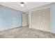 Bedroom with blue walls, a closet and white shuttered doors leading to the hall at 4314 Deep Springs Nw Ct, Kennesaw, GA 30144