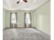 This bedroom is a spacious, light-filled room with two windows and a ceiling fan at 4314 Deep Springs Nw Ct, Kennesaw, GA 30144