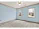 Bedroom with blue walls, two large windows, carpet, wallpaper trim and ceiling fan at 4314 Deep Springs Nw Ct, Kennesaw, GA 30144