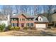 Charming two-story brick home with well-manicured lawn, green shutters, and a welcoming front door at 4314 Deep Springs Nw Ct, Kennesaw, GA 30144
