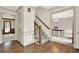 Hallway with hardwood floors, staircase, and decorative trim, leading to the dining room at 4314 Deep Springs Nw Ct, Kennesaw, GA 30144