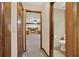 Hallway view featuring a full bathroom and a large fireplace in the open living area at 4314 Deep Springs Nw Ct, Kennesaw, GA 30144