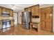 Kitchen with wood cabinets, stainless steel fridge and appliances, hardwood floors and granite counters at 4314 Deep Springs Nw Ct, Kennesaw, GA 30144