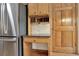 Desk area with storage, granite countertop, and stainless steel refrigerator at 4314 Deep Springs Nw Ct, Kennesaw, GA 30144