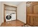 Laundry room with wood floors, washer, dryer and wooden door at 4314 Deep Springs Nw Ct, Kennesaw, GA 30144
