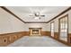 Spacious living room features paneled walls, ceiling fan, and a large brick fireplace at 4314 Deep Springs Nw Ct, Kennesaw, GA 30144