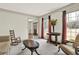 Cozy living room with neutral walls, carpet flooring, traditional furnishings, and bright window views at 4314 Deep Springs Nw Ct, Kennesaw, GA 30144