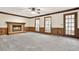 Living room with brick fireplace, paneled walls, carpet, and large windows at 4314 Deep Springs Nw Ct, Kennesaw, GA 30144