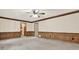 Spacious living room with paneled walls, carpet, and multiple entryways at 4314 Deep Springs Nw Ct, Kennesaw, GA 30144