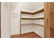 Walk-in pantry with wooden shelving and wire rack storage at 4314 Deep Springs Nw Ct, Kennesaw, GA 30144