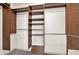 Spacious walk-in closet with built in wooden shelving and ample space for storage at 4314 Deep Springs Nw Ct, Kennesaw, GA 30144