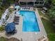 Aerial view of a private backyard oasis featuring a spacious pool, patio, and lush landscaping at 4010 Tamarack Nw Dr, Kennesaw, GA 30152