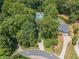 An aerial view of a home with a beautiful pool and large manicured yard and surrounding trees at 4010 Tamarack Nw Dr, Kennesaw, GA 30152