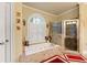 Luxurious bathroom featuring soaking tub, walk-in shower and tiled floors at 4010 Tamarack Nw Dr, Kennesaw, GA 30152
