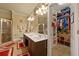 Bright primary bathroom with double vanity, walk-in shower, and walk-in closet with custom shelving at 4010 Tamarack Nw Dr, Kennesaw, GA 30152