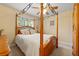 Bedroom featuring a four-poster bed, ceiling fan, and ample natural light at 4010 Tamarack Nw Dr, Kennesaw, GA 30152