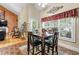 Sunlit breakfast nook featuring large windows, table with four chairs, and brick floors at 4010 Tamarack Nw Dr, Kennesaw, GA 30152
