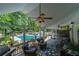 Covered deck overlooking a large swimming pool, with an outdoor ceiling fan and comfortable seating at 4010 Tamarack Nw Dr, Kennesaw, GA 30152