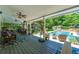 Back porch with outdoor seating overlooking a large pool and green backyard at 4010 Tamarack Nw Dr, Kennesaw, GA 30152
