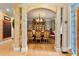 Formal dining room featuring decorative columns, hardwood floors, chandelier, and elegant china cabinet at 4010 Tamarack Nw Dr, Kennesaw, GA 30152