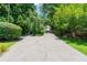 Long driveway with a beautifully landscaped yard and mature trees at 4010 Tamarack Nw Dr, Kennesaw, GA 30152