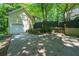 Side of house with a 2-car garage, driveway, and steps leading to a backyard porch at 4010 Tamarack Nw Dr, Kennesaw, GA 30152