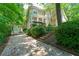 View of home featuring a covered front porch, stone accents and lush landscaping at 4010 Tamarack Nw Dr, Kennesaw, GA 30152