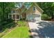 Charming home featuring a covered front porch, well-manicured lawn and an attached garage at 4010 Tamarack Nw Dr, Kennesaw, GA 30152