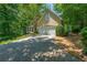 Picture of a house exterior, featuring an attached garage, nice lawn and mature landscaping at 4010 Tamarack Nw Dr, Kennesaw, GA 30152