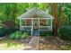 Charming front porch with stone accents, complemented by mature trees and landscaping at 4010 Tamarack Nw Dr, Kennesaw, GA 30152