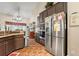 Bright kitchen featuring stainless appliances, dark wood cabinets and brick floor at 4010 Tamarack Nw Dr, Kennesaw, GA 30152