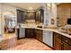 Gourmet kitchen featuring modern appliances, brick floors and dark wood cabinets at 4010 Tamarack Nw Dr, Kennesaw, GA 30152
