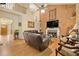 Open-concept living room showcasing hardwood floors, vaulted ceiling and a stone fireplace at 4010 Tamarack Nw Dr, Kennesaw, GA 30152