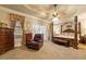 Large main bedroom with tray ceiling, ceiling fan and seating area at 4010 Tamarack Nw Dr, Kennesaw, GA 30152