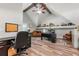Well-lit home office with vaulted ceilings, wood beams, and ample space for productivity at 4010 Tamarack Nw Dr, Kennesaw, GA 30152