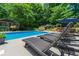 Lounge chairs near the sparkling pool, perfect for relaxing and enjoying the outdoors at 4010 Tamarack Nw Dr, Kennesaw, GA 30152