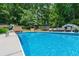 Beautiful in-ground pool with sun loungers surrounded by a landscaped yard, offering a serene escape at 4010 Tamarack Nw Dr, Kennesaw, GA 30152